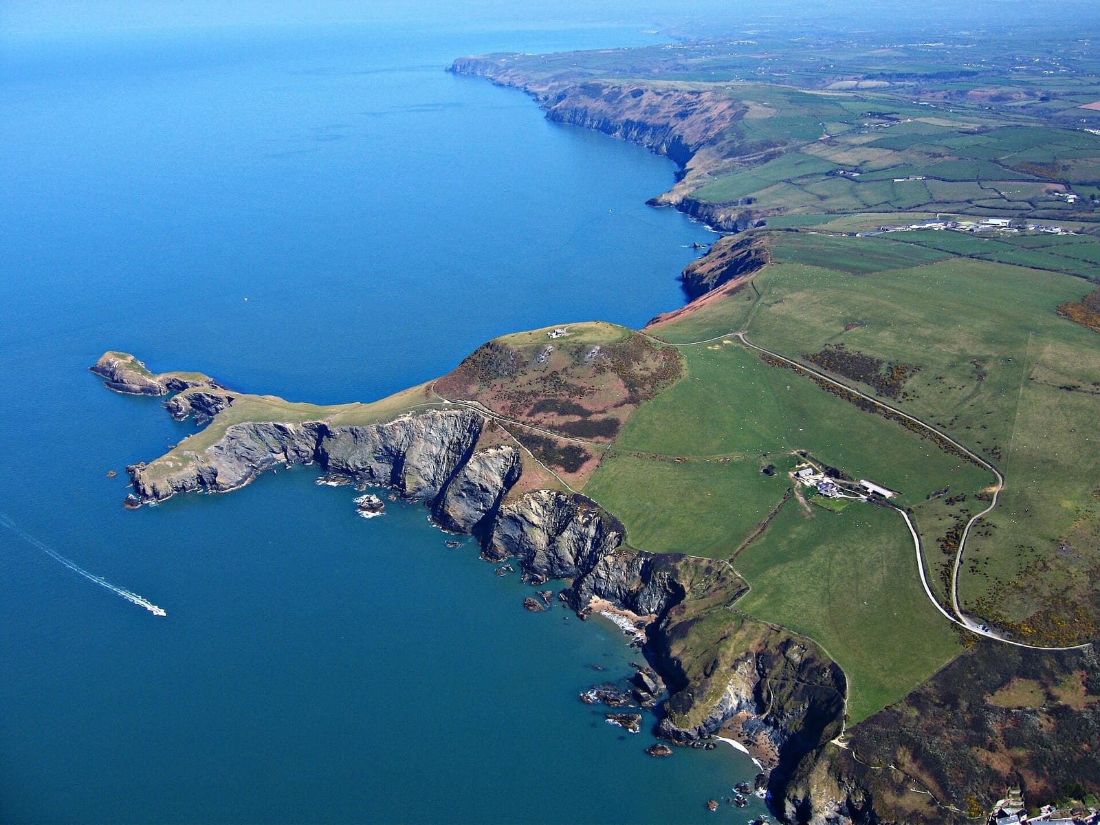 Aerial view of the Ynys-Lochtyn headland reaching into Cardigan Bay