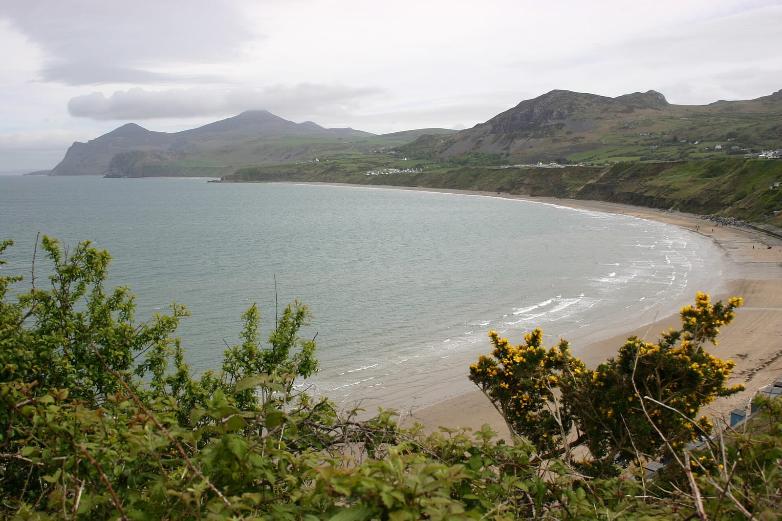 A curving sandy bay backed by hills near Nefyn on the Llyn Peninsula