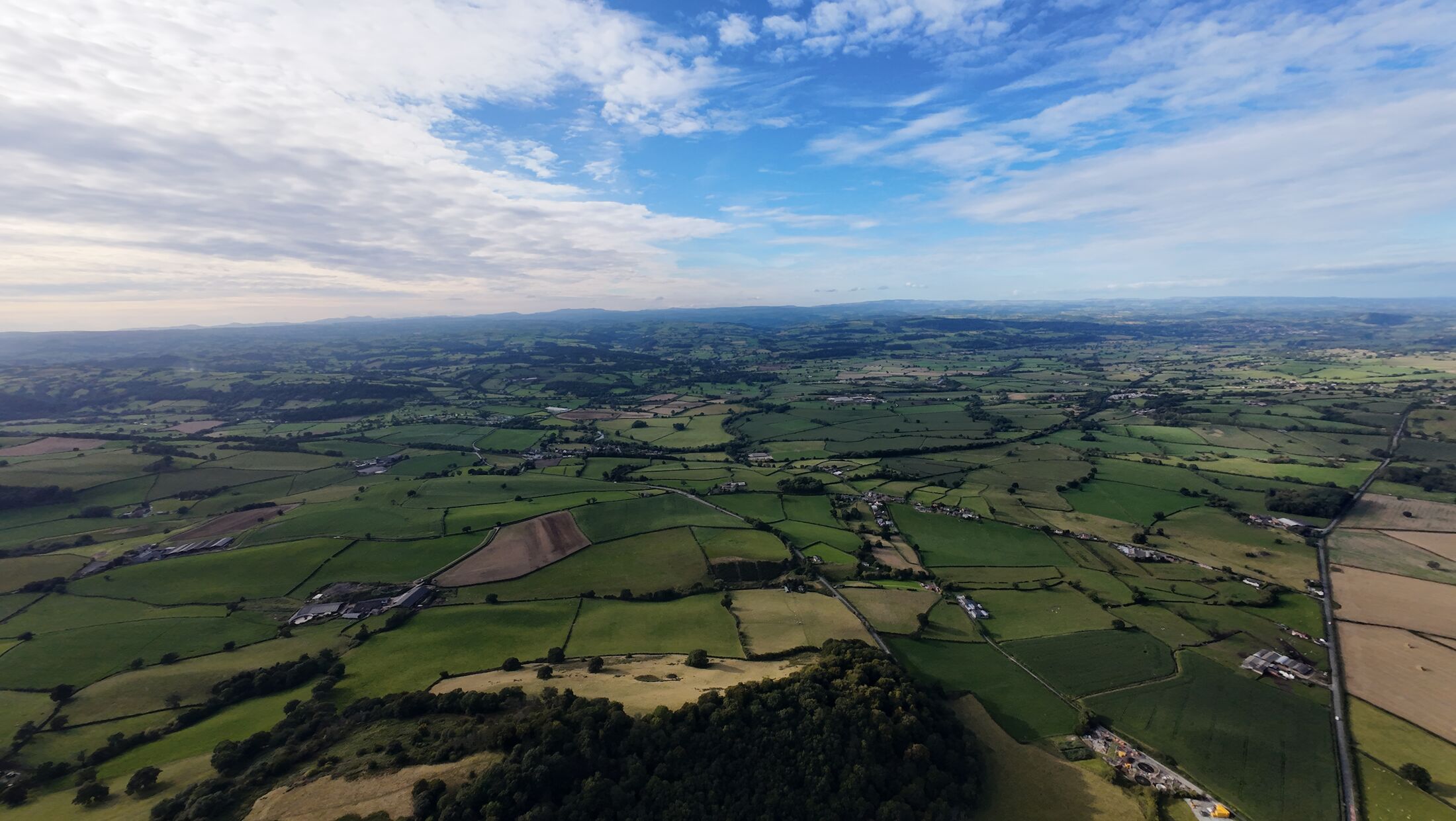 Aerial view of patchwork farmland in the Mid Wales borders near Montgomery
