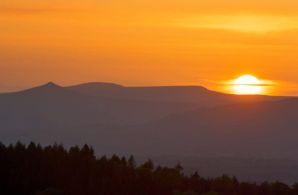 The Sugar Loaf and Skirrid hills above Abergavenny at sunset