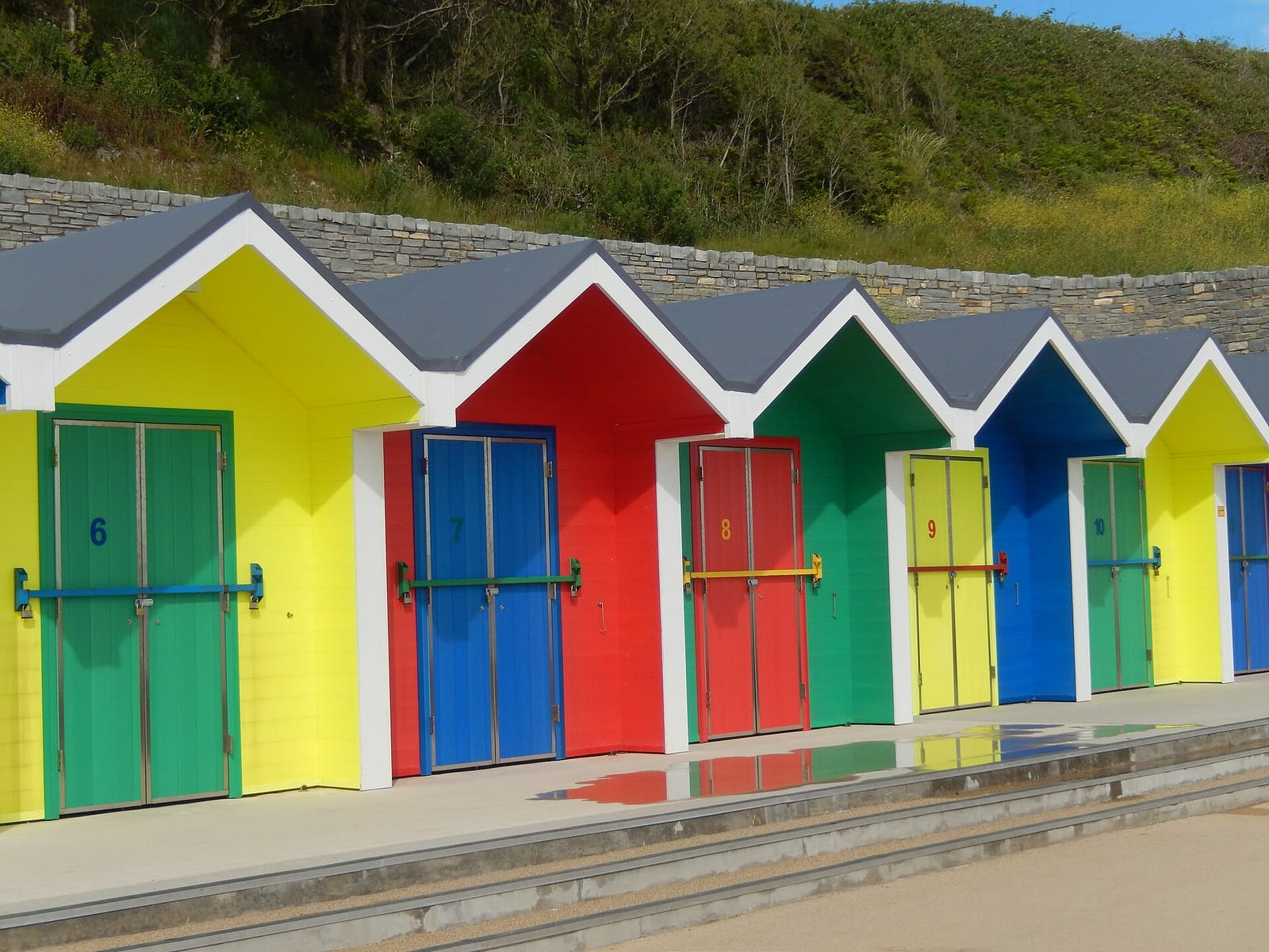 Colourful beach huts above the sands at Barry Island
