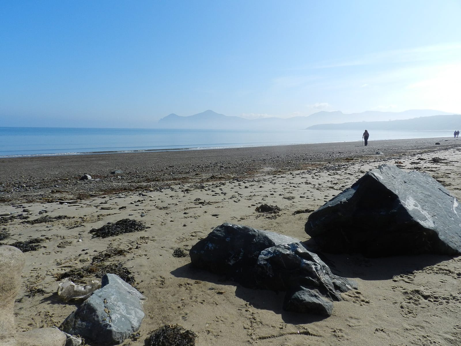 Walkers on Morfa Nefyn beach on the Llyn Peninsula